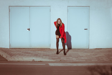 Beautiful girl posing with red coat
