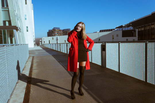 Beautiful girl with red coat talking on phone