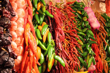 hanging bunches of red and green peppers