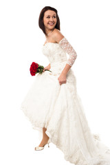 Fototapeta premium Pretty bride turns back and moving forward