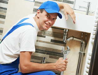 Young smiling plumber man worker