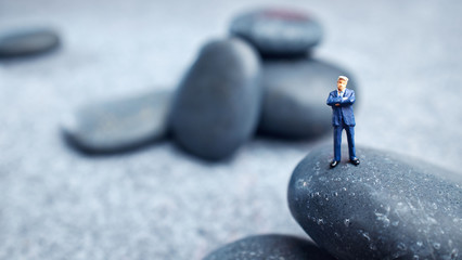 Business miniature  figures and rocks