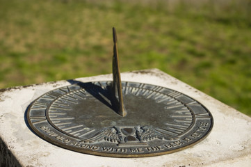 Bronze sundial with inscription and shadow