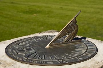 Bronze sundial with inscription - obrazy, fototapety, plakaty