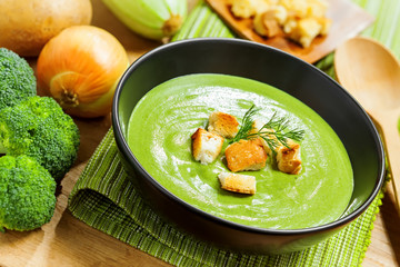 Broccoli cream soup and ingredients on table