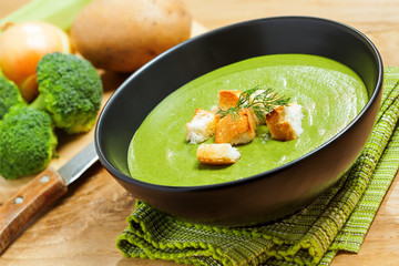 Broccoli cream soup and ingredients on table