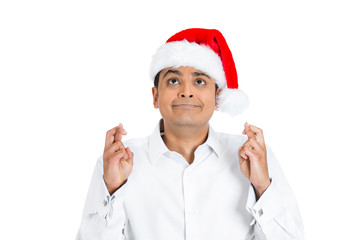 Christmas man crossing fingers, hoping for the best in new year