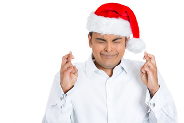 Fototapeta na wymiar Christmas man crossing fingers, hoping for the best in new year