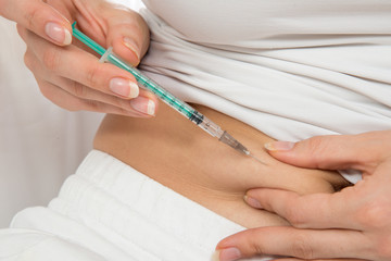 Doctor making diabetes patient insulin shot by syringe