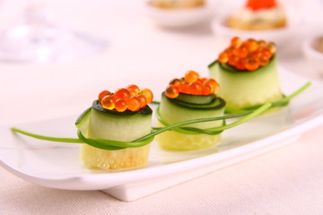 Red caviar on fresh cucumber as snack