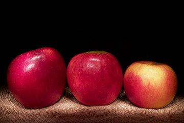Fototapeta na wymiar Three apples on black background