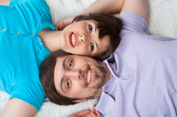Relaxing couple lying in bed