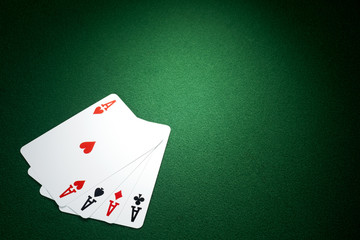 Four aces  on a green felt