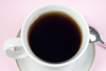 cup of coffee on pink tablecloth