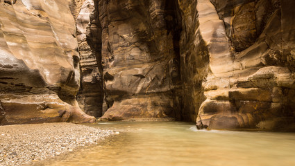 Flowing river in canyon of Wadi Mujib, Jordan - obrazy, fototapety, plakaty