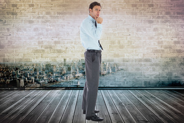 Composite image of thoughtful businessman with hand on chin