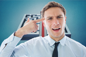 Composite image of businessman making gun gesture