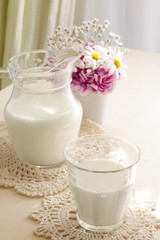 Obraz na płótnie Canvas Milk and flower on table
