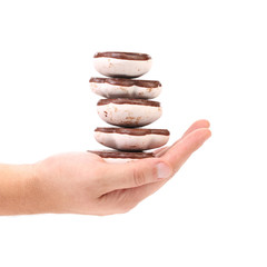 Hand holds stack of chocolate meringues.