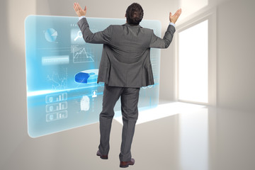 Fototapeta premium Composite image of businessman posing with arms raised