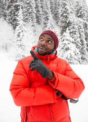 Fototapeta na wymiar African American Cheerful black man in ski suit in snowy