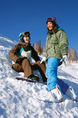 Fototapeta na wymiar Two cheerful snowboarders