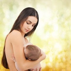 happy mother feeding her adorable baby