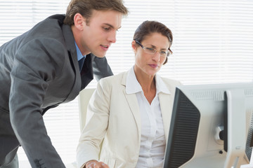Smartly dressed business couple using computer