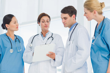 Fototapeta premium Doctors looking at report in hospital