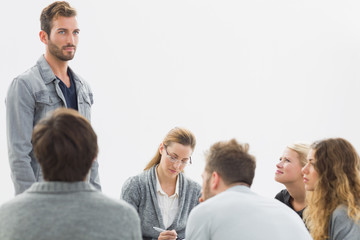 Group therapy in session sitting in a circle