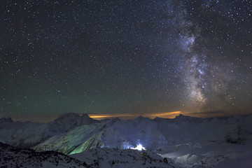 Milky Way and the moon over the Caucasus mountains