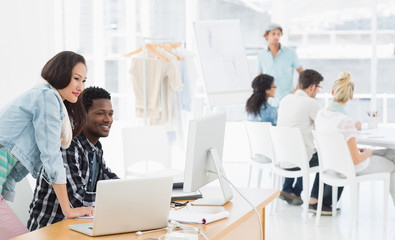 Artists working at desks in creative office