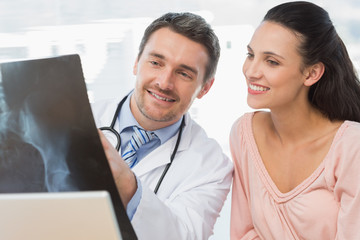 Doctor explaining x-ray report to a smiling patient
