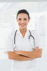 Smiling beautiful female doctor with arms crossed