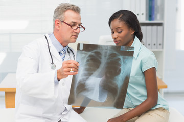 Doctor showing young patient her chest xray