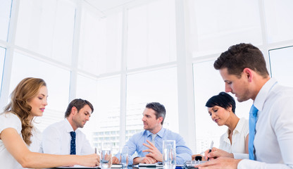 Executives sitting around conference table