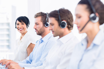 Business colleagues with headsets in a row