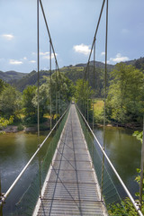 Fototapeta na wymiar suspension bridge over a wide river