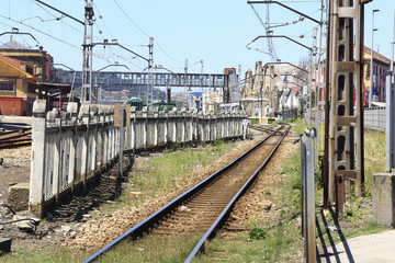 Fototapeta na wymiar rail train entering a station, with many utility poles