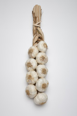 String of garlic on wooden background