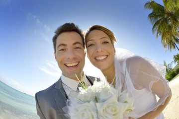 Portrait of just married couple by the beach