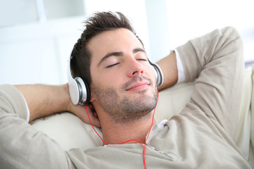 Young man listening to music with headphones