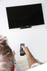 Closeup of remote control and tv set