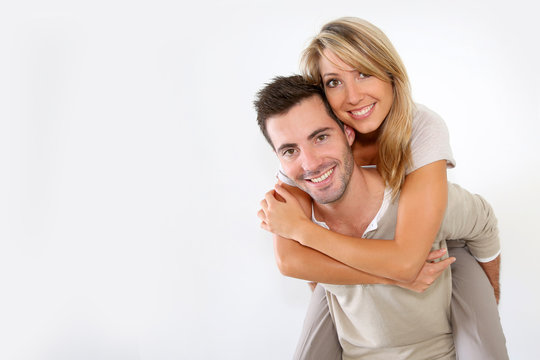Cheerful couple standing on white background