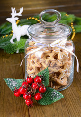 Delicious Christmas cookies in jar on table close-up