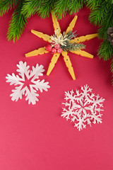 Fototapeta na wymiar Beautiful snowflakes with fir branch on pink background