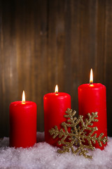 Burning candles on wooden background