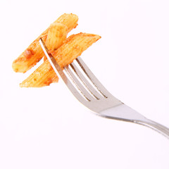 Pesto rosso on a fork on a white background