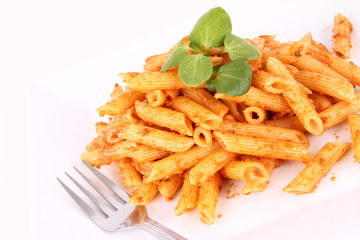 Pasta with pesto rosso decorated with cress