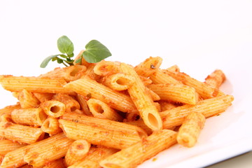 Pesto rosso being decorated with cress